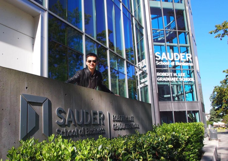 Mike Shen posing infront of the Henry Angus Building at the UBC Sauder School of Business in Vancouver